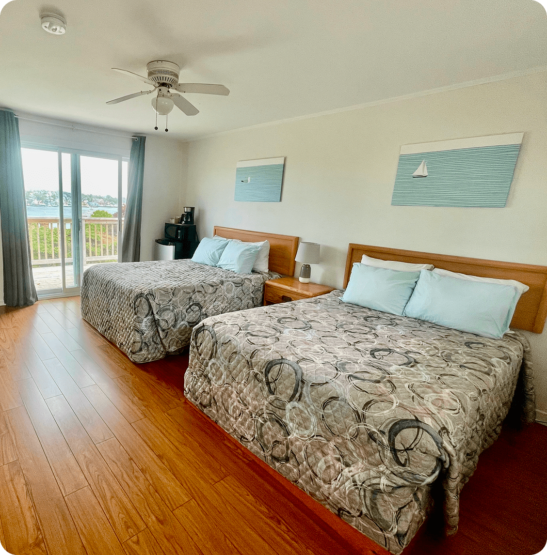 Hotel room with two beds and balcony.